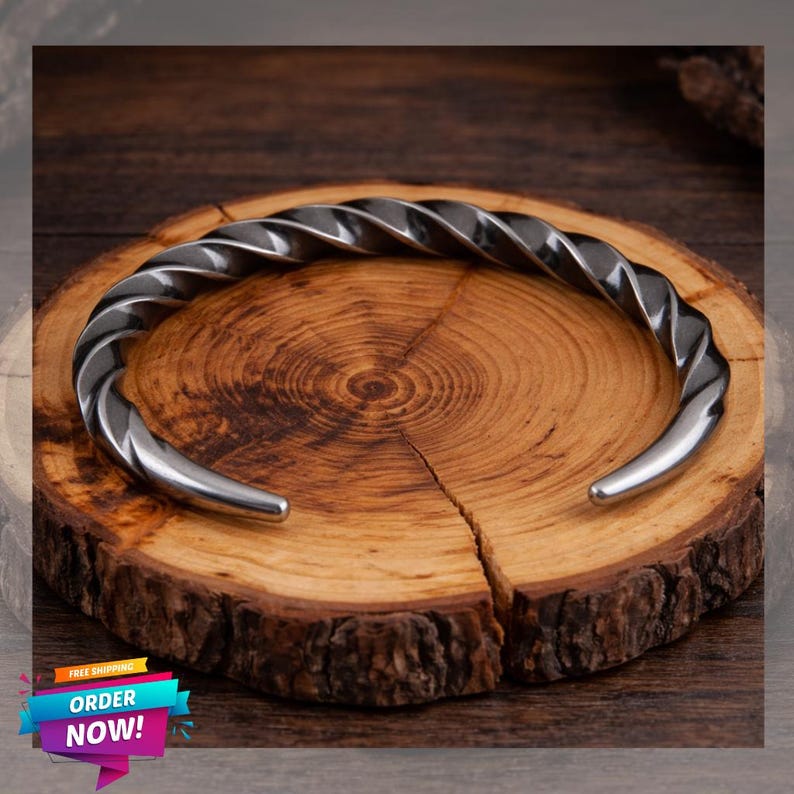 Viking twisted stainless steel cuff bracelet on dark wood